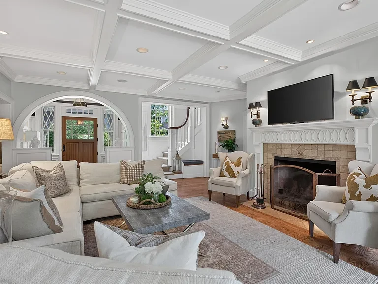Bright sitting room framed by arched openings and custom woodwork
