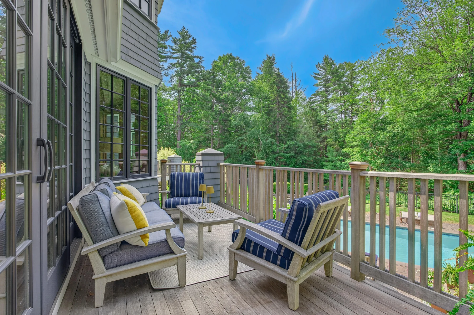 Outdoor deck overlooking the pool and landscaped garden