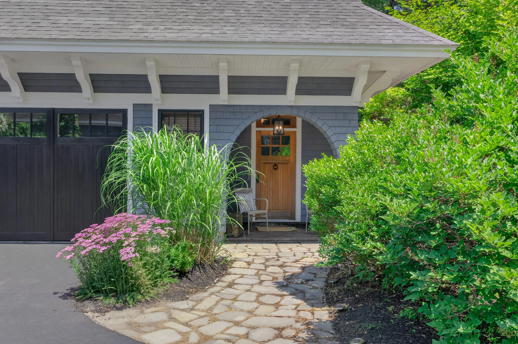 Stone path leading to the arched carriage-house entrance