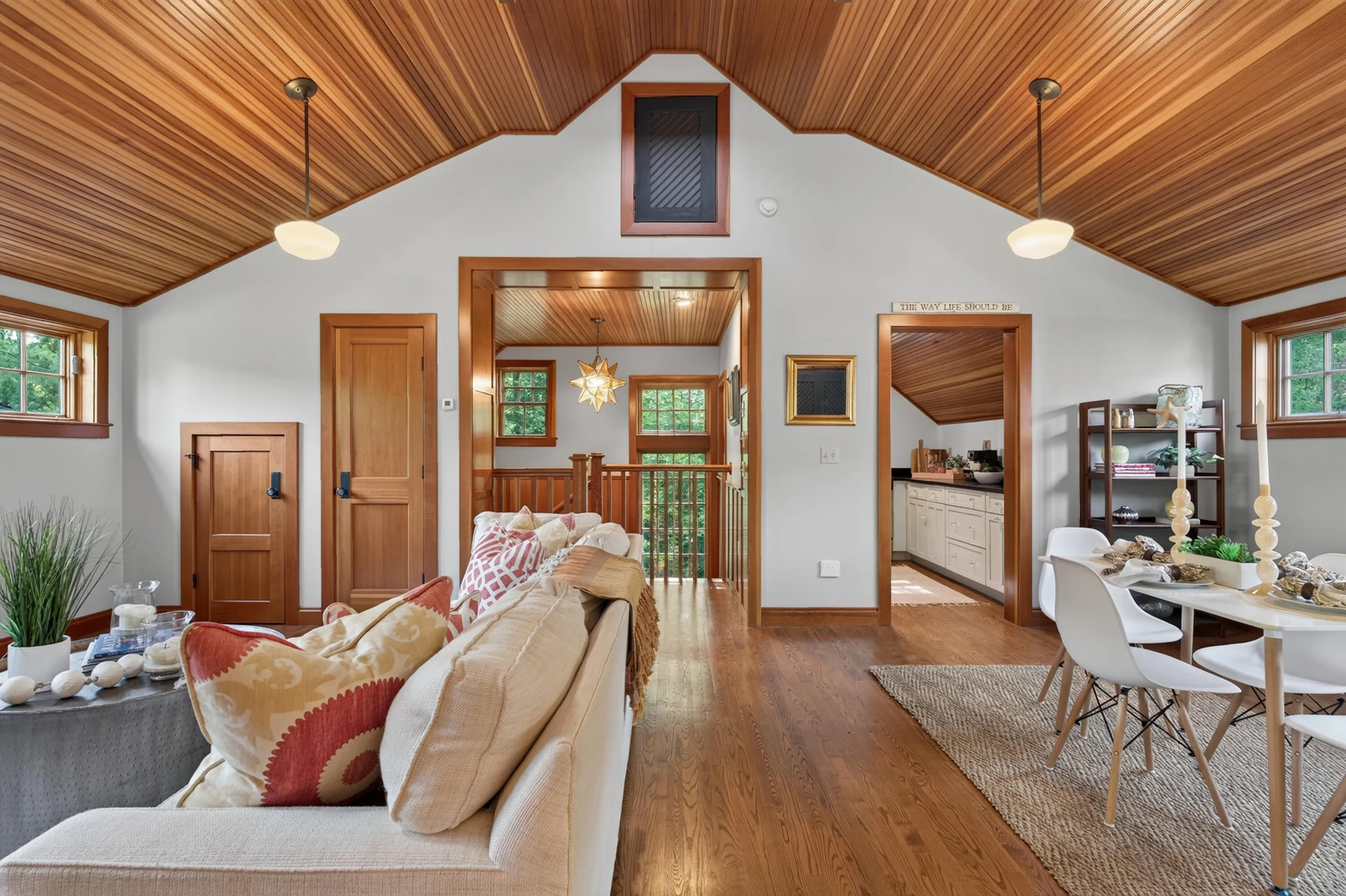 Carriage-house living room beneath a vaulted wood ceiling