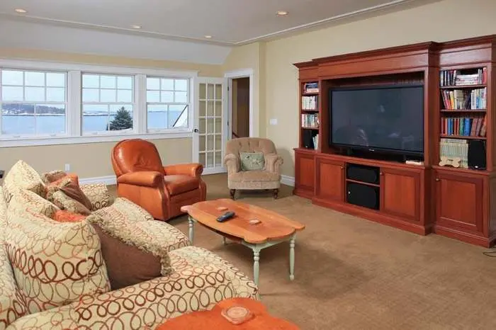 Living room with a built-in wood media wall and shelving