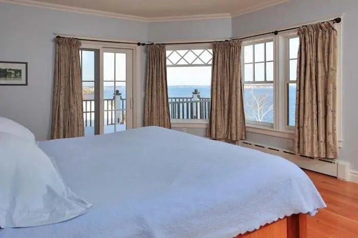 Bedroom with ocean views through a row of windows
