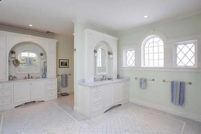 White fitted bathroom vanity with arched windows