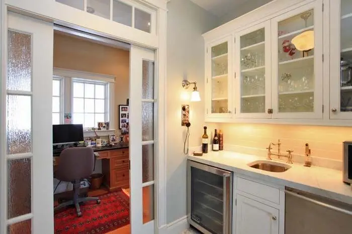 Bathroom with a fitted vanity, framed mirror, and stone counter